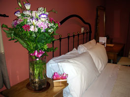 Bedroom facilities with flowers and chocolates